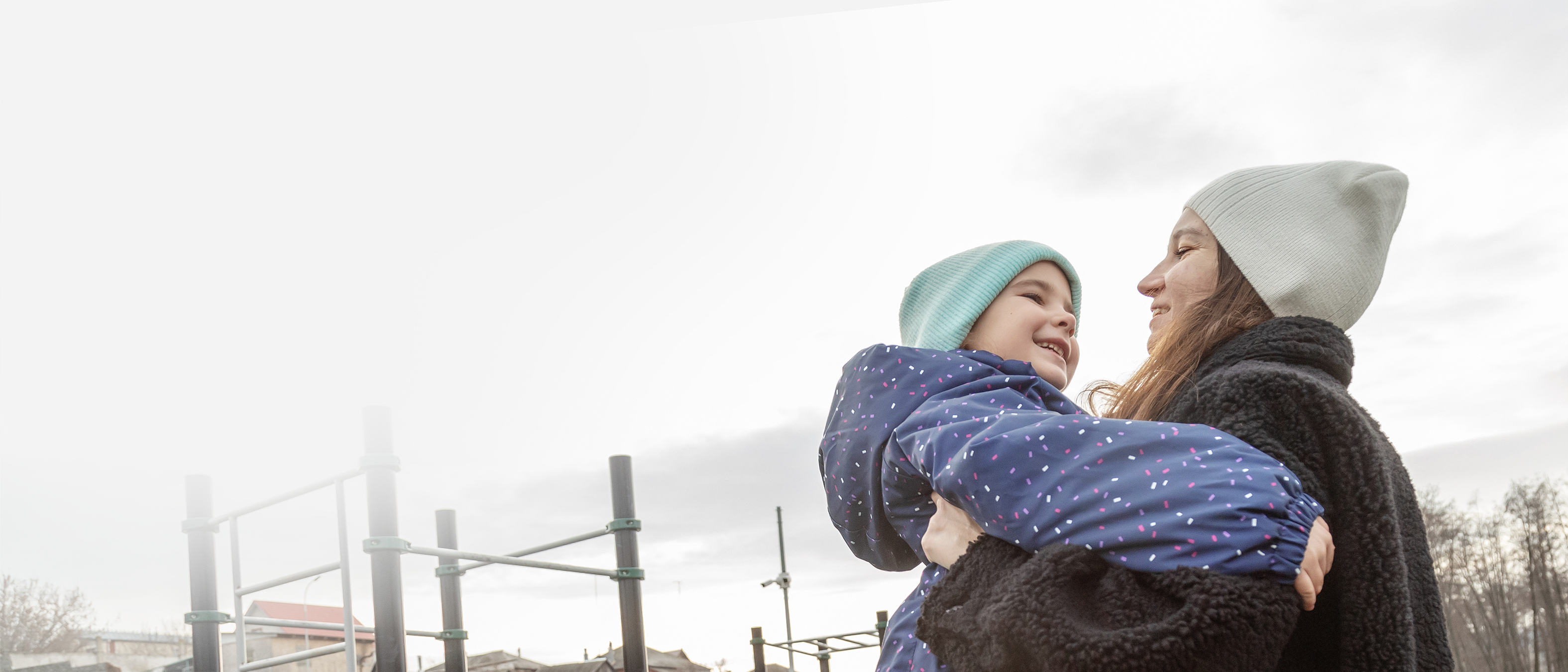 Mother holding child in playground