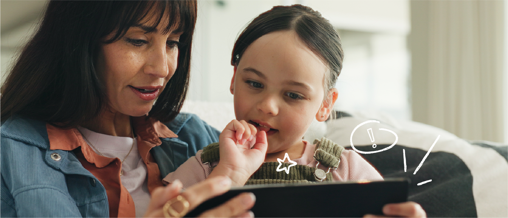 Mother and child viewing tablet device