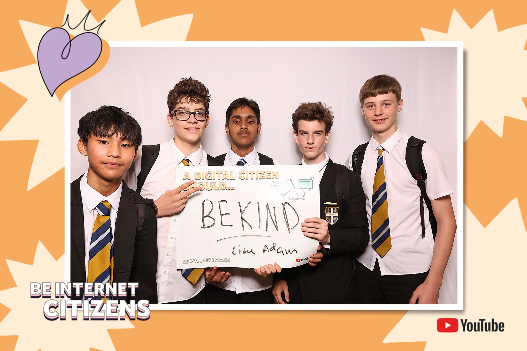 student in a photo booth with 'be kind' on the internet