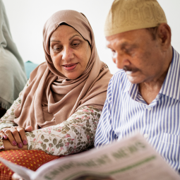 Husband and wife reading newspaper