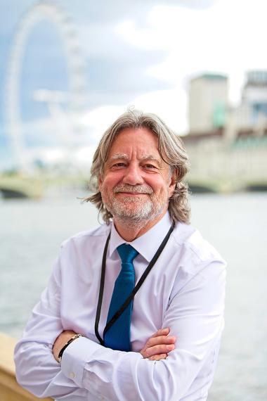 A photograph of Paul Finnis with the London Eye in the background