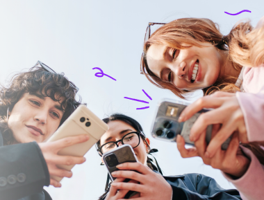Three friends on phones outdoors