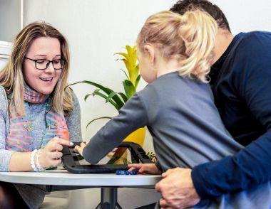 A professional working with a child and their parent